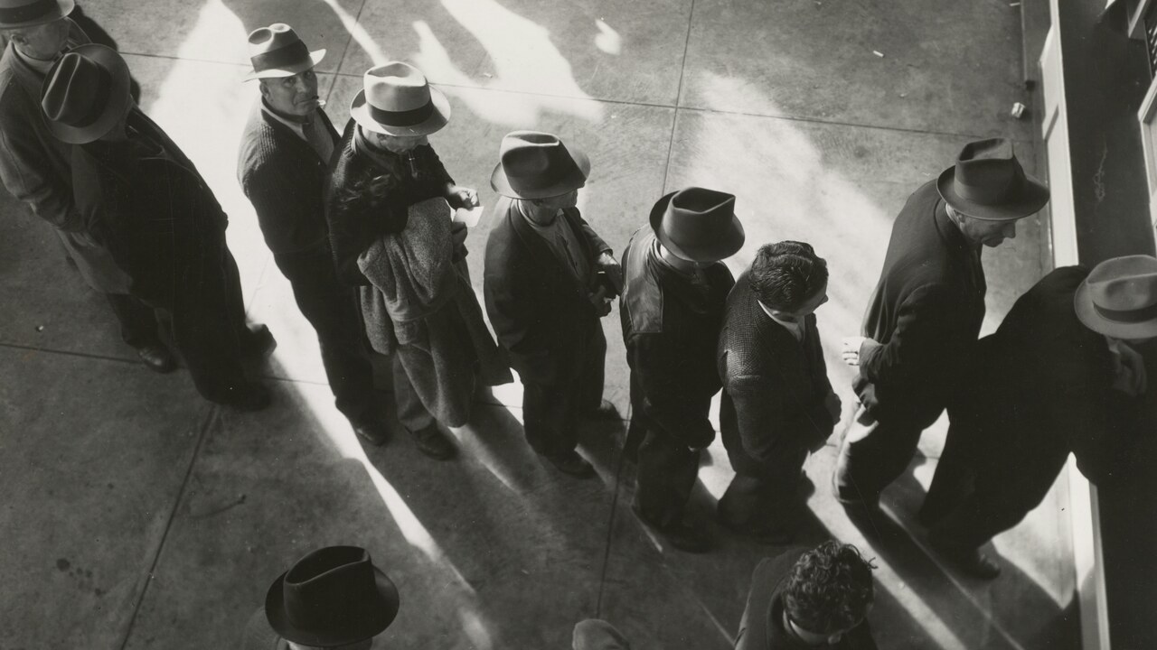 Black-and-white overhead view of people waiting in line
