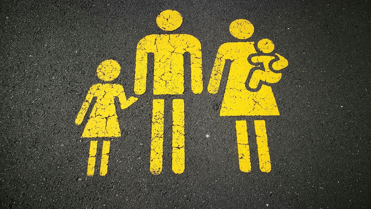 Painted pictogram of a family on asphalt